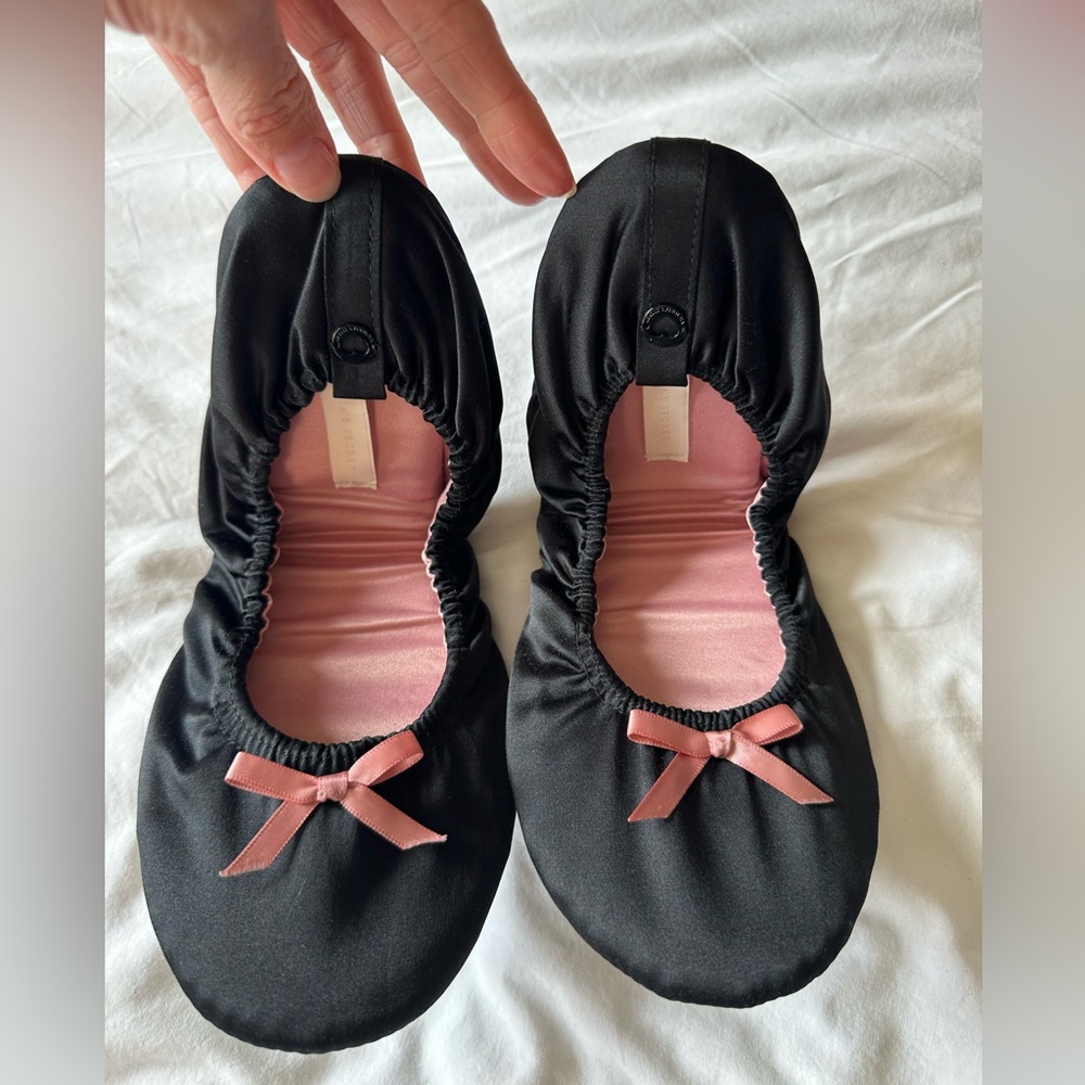 Black slippers with pink bows